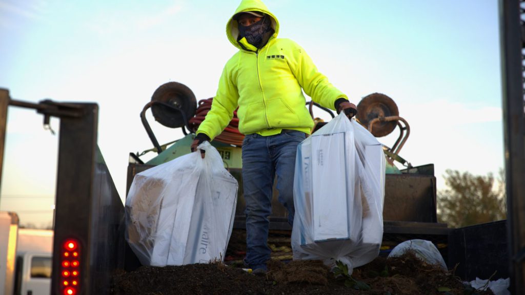 SLD crew member cleaning up a project site.