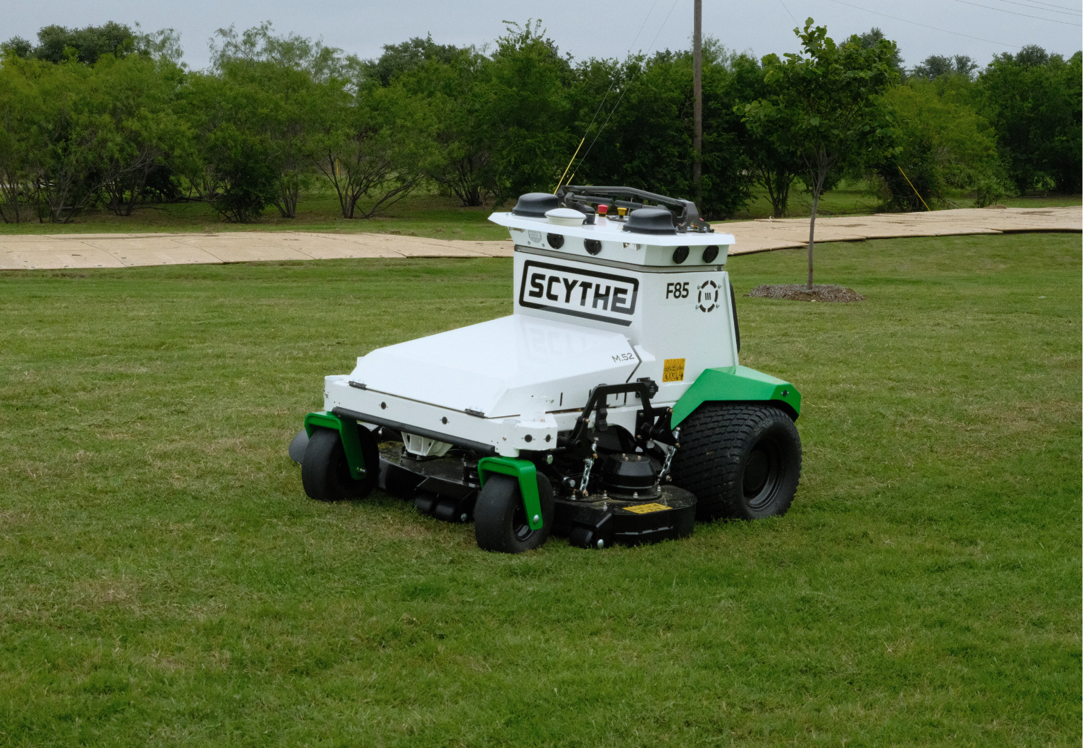 Automatic Scythe robotic mower performing commercial grass mowing at a Site Landscape Development property