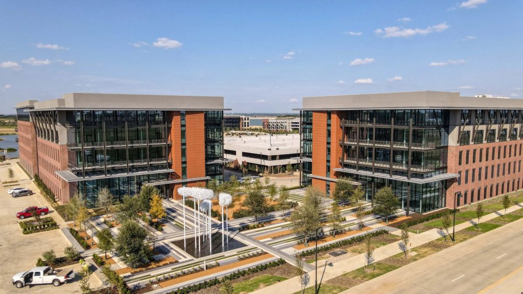 Newly installed trees across a commercial landscape project in Coppell, Texas following crane-assisted installation