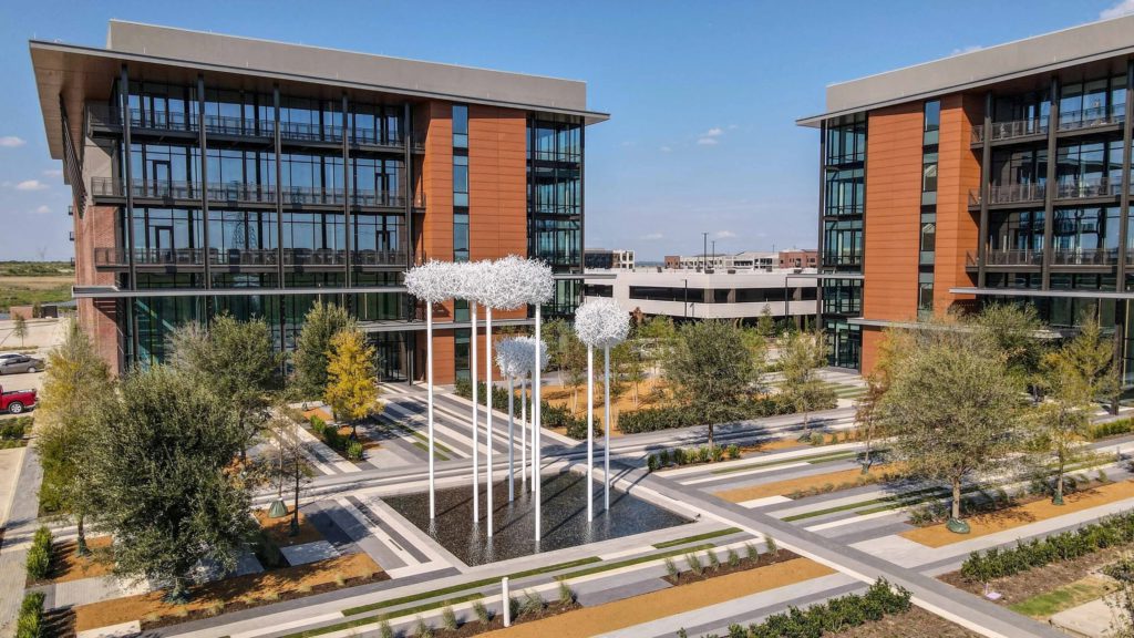 Newly installed trees across a commercial landscape project in Coppell, Texas following crane-assisted installation