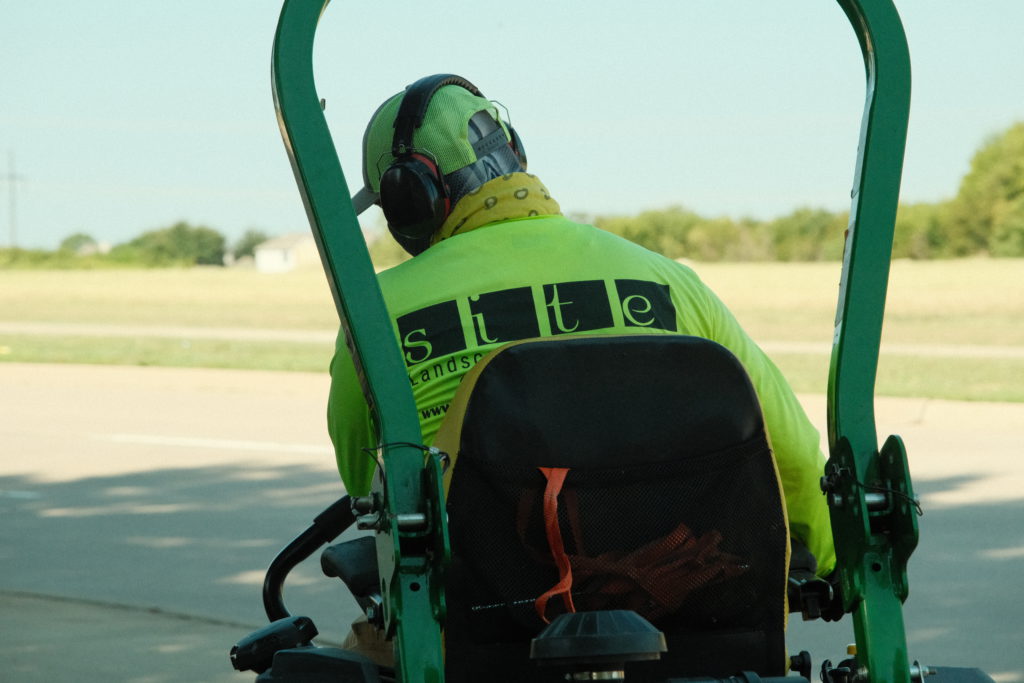 SLD worker close-up shot on John Deere mower
