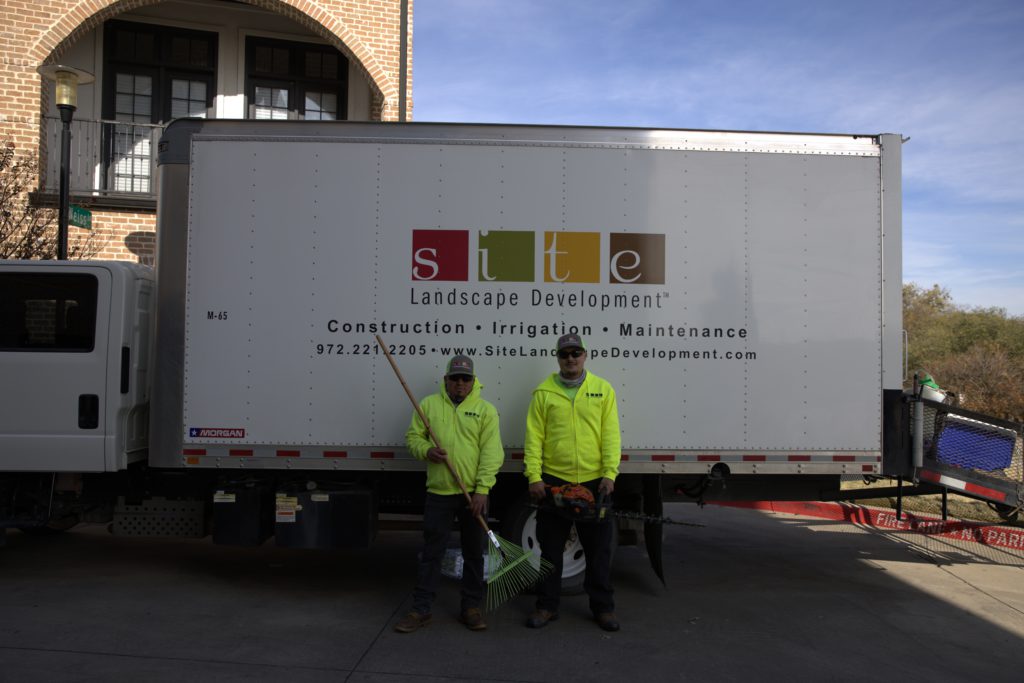 SLD crew members posing beside a work truck before starting a project.