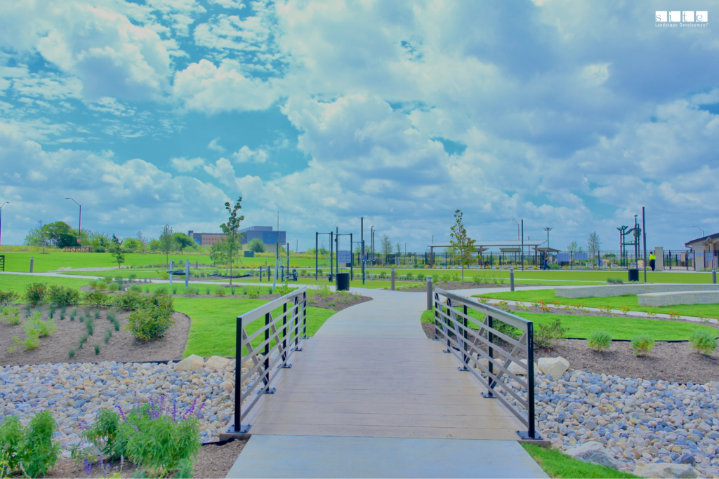 Detailed view of the bridge and river rock landscaping at the Rock Creek West amenity center in Fort Worth, with rockscape work completed by SLD.