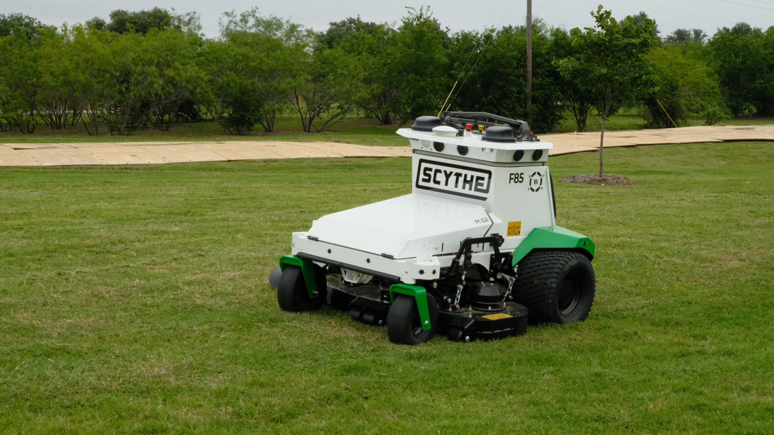 Automatic Scythe robotic mower performing commercial grass mowing at a Site Landscape Development property