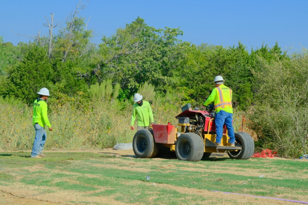 SLD crew members rolling newly installed sod at Passport Park West, an industrial development near DFW Airport in Irving, TX.