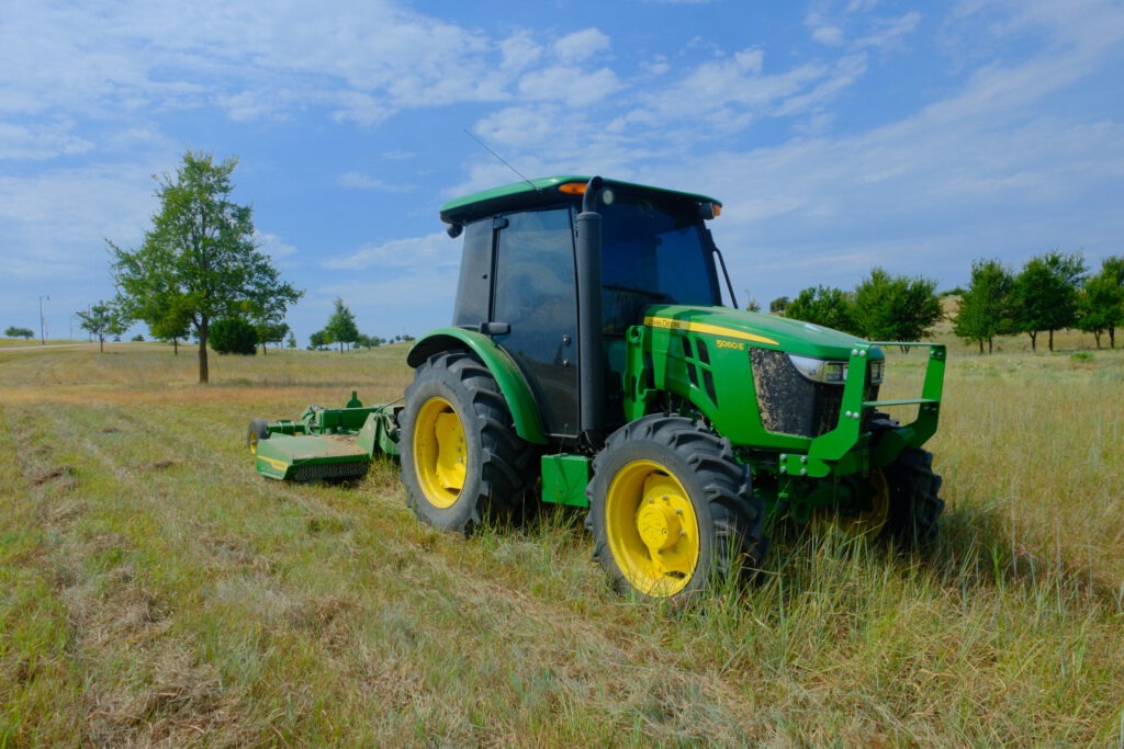 Close-up of an SLD tractor and rotary mower at Walsh, a master-planned community in Fort Worth, TX.