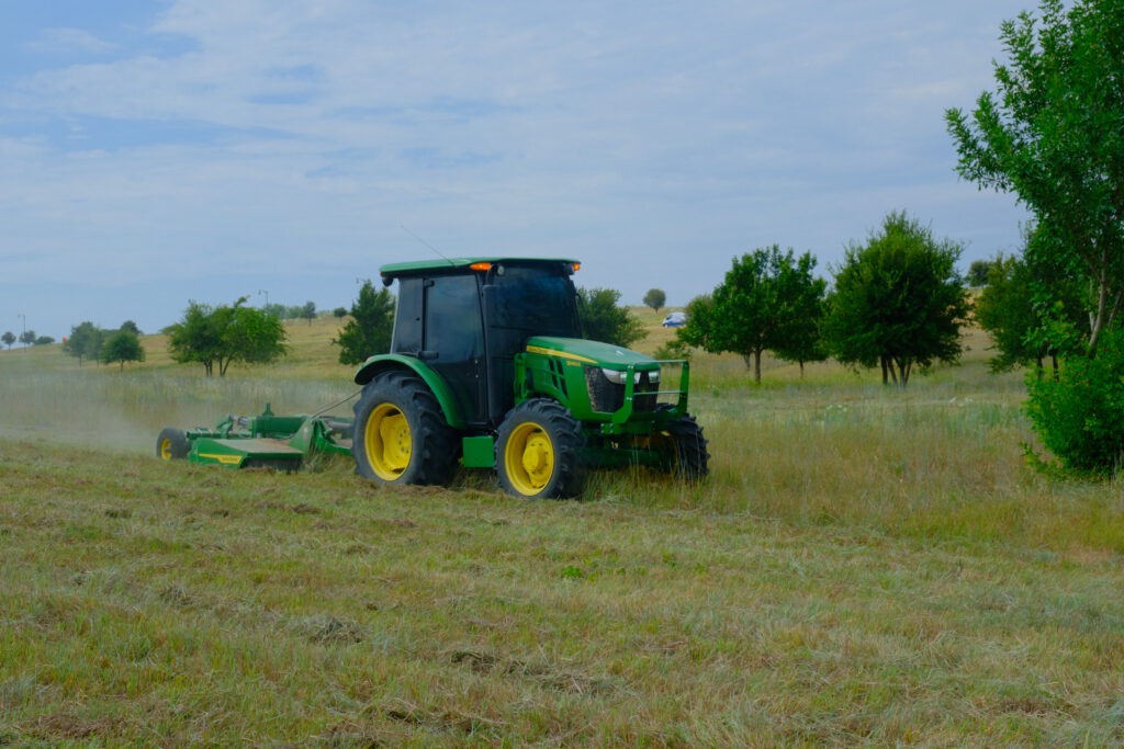 SLD crew member mowing a large open field at Walsh, a master-planned community in Fort Worth, TX.